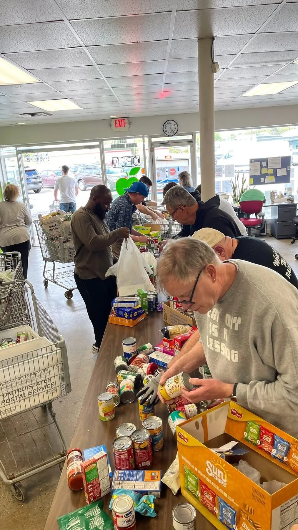 Volunteers sorting donated food items at the Green Apple Pantry